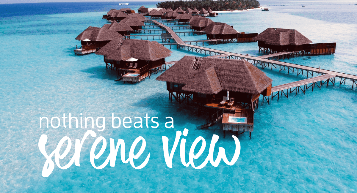 Aerial view of overwater bungalows on clear blue water