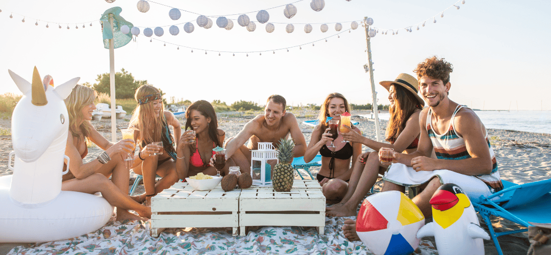 Group of friends at a destination birthday party on a beach