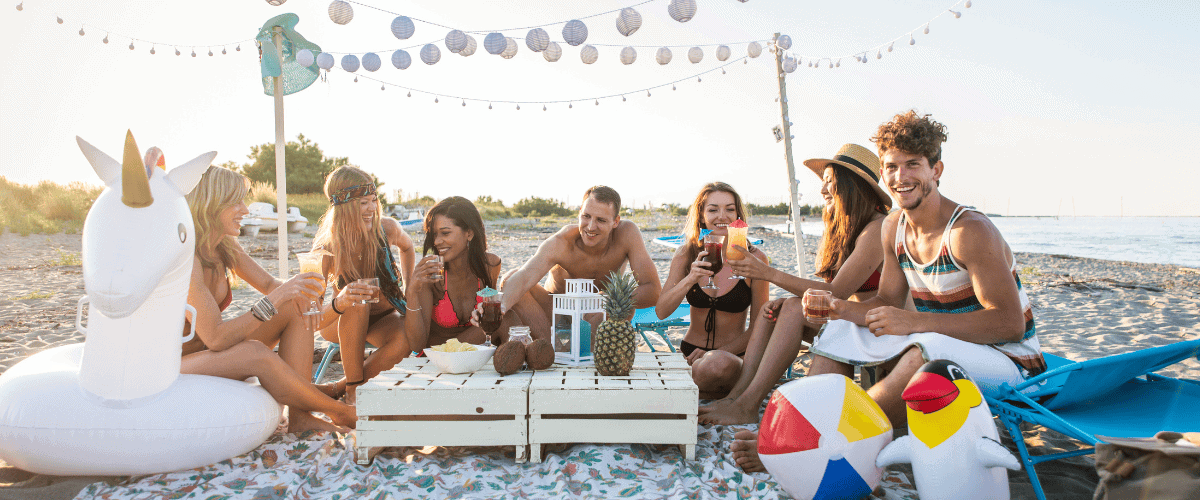 Group of friends at a destination birthday party on a beach