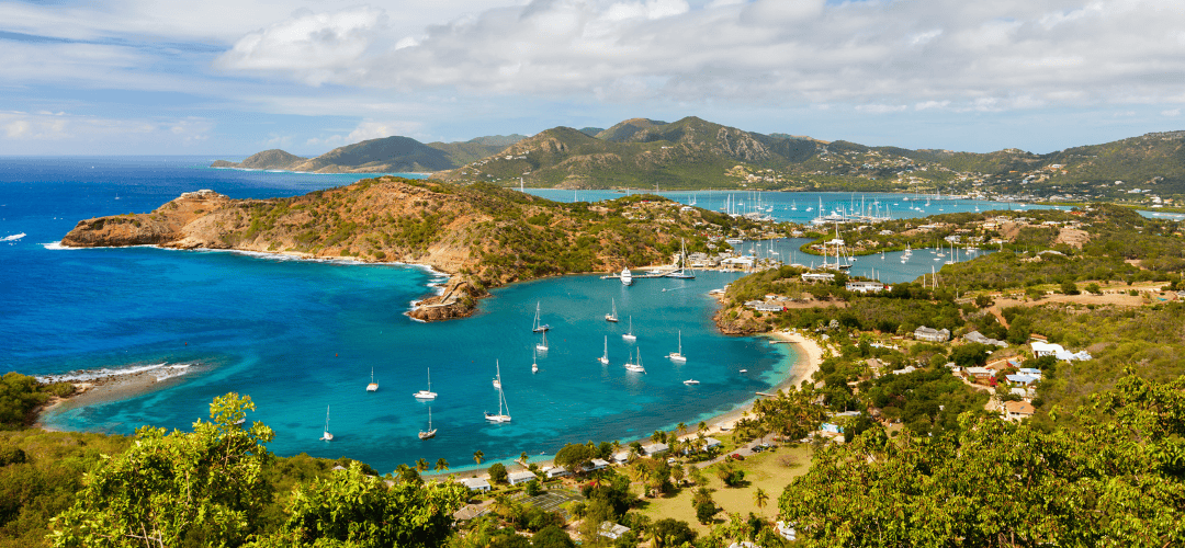 Overhead view of a caribbean island with blue water and mountains