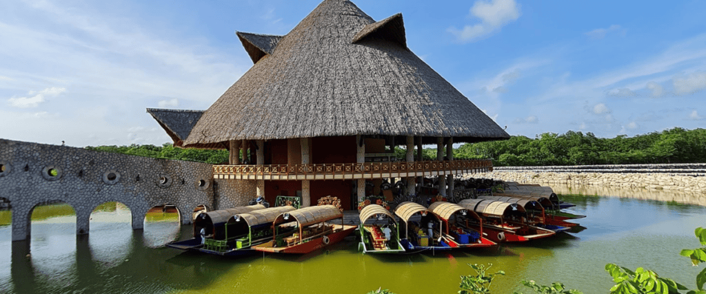 Xoximilco in Cancun with floating gondolas parked at a big tiki hut