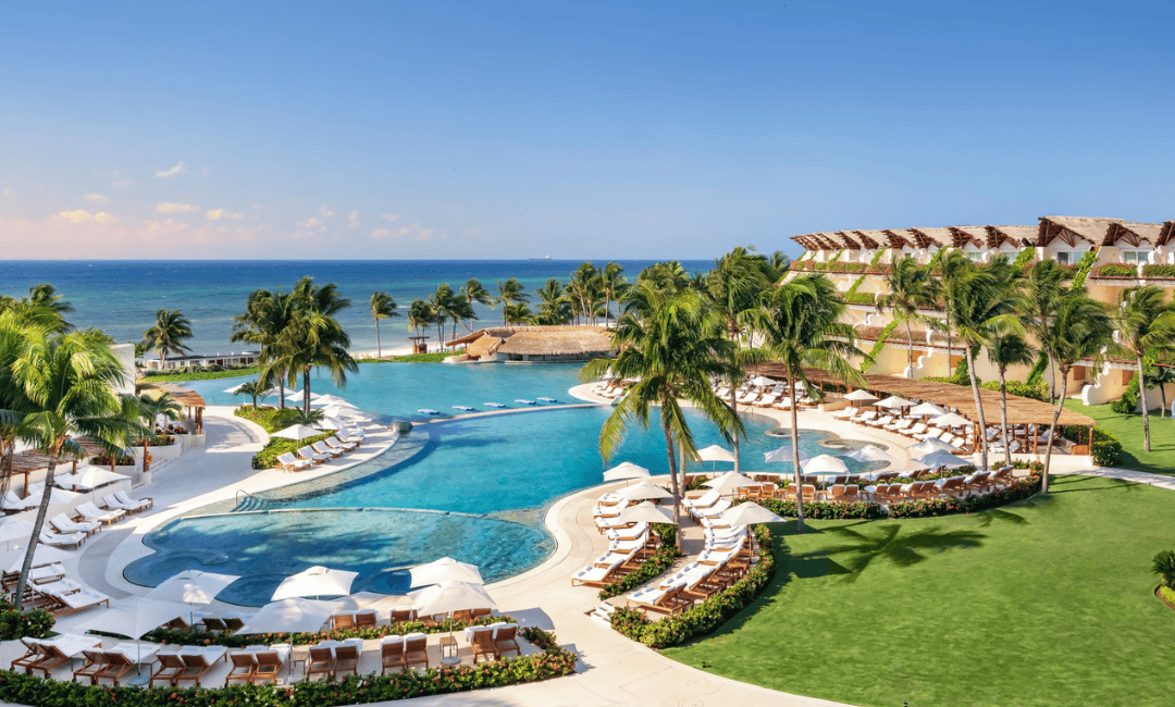 View of an all-inclusive resort showing the pool area and buildings overlooking the ocean