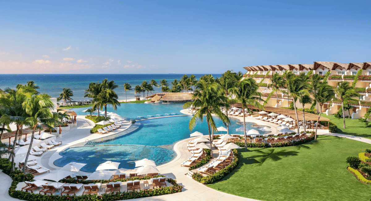 View of an all-inclusive resort showing the pool area and buildings overlooking the ocean