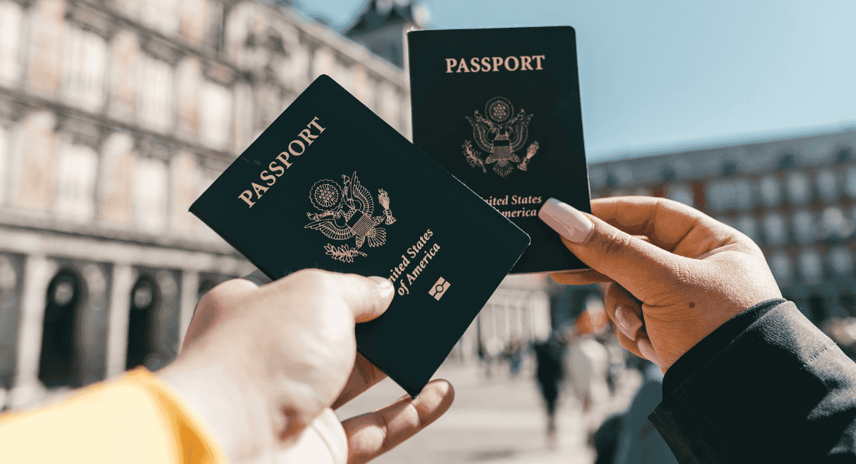 Two people holding up United States passports