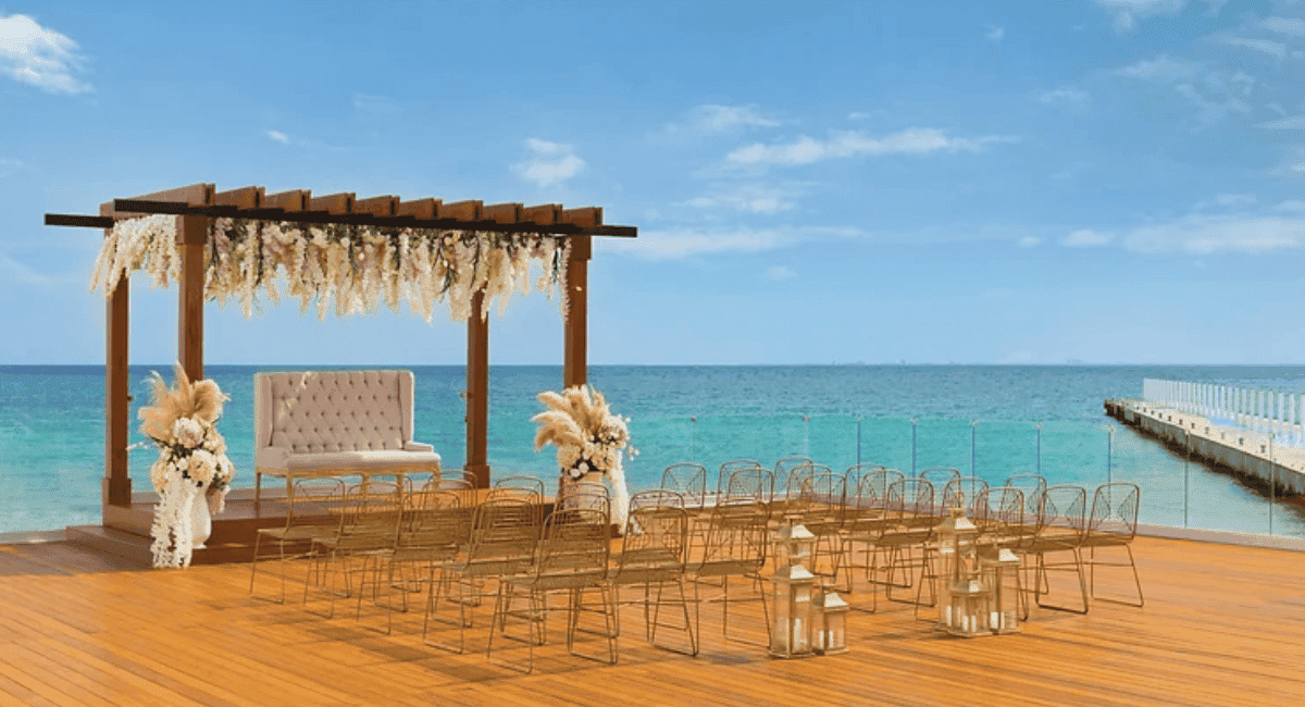 Beach destination wedding setup with an over the water dock