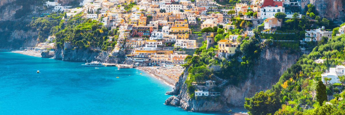 Sky view of Italy blue waters and a cliffside full of Italy homes