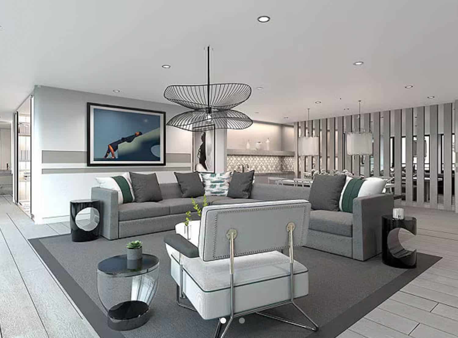 Modern open-plan cruise ship living room with grey sofas, black light fixture, contemporary artwork, and a view of the kitchen and dining area.
